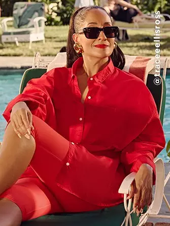A female model wearing red linen button-down shirt and red PowerSoft cropped leggings.