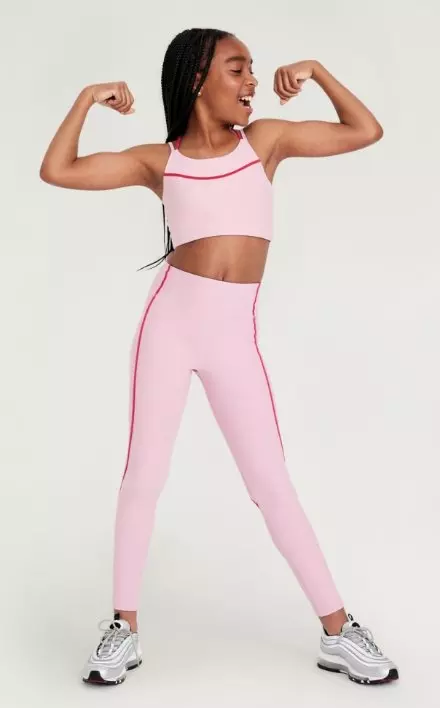 A female model wears pink activewear leggings