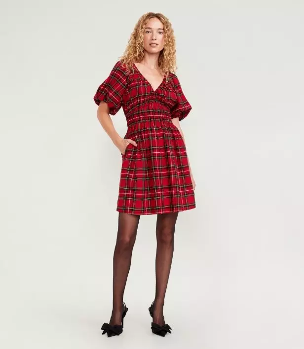 Image of a model wearing red plaid waist-defined mini dress.