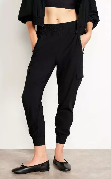 A female model wears High-Waisted SleekTech Joggers.