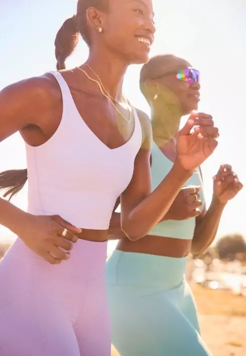 Female models are running wearing Old Navy Run + Train activewear.