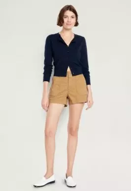 A female model wearing tailored shorts.