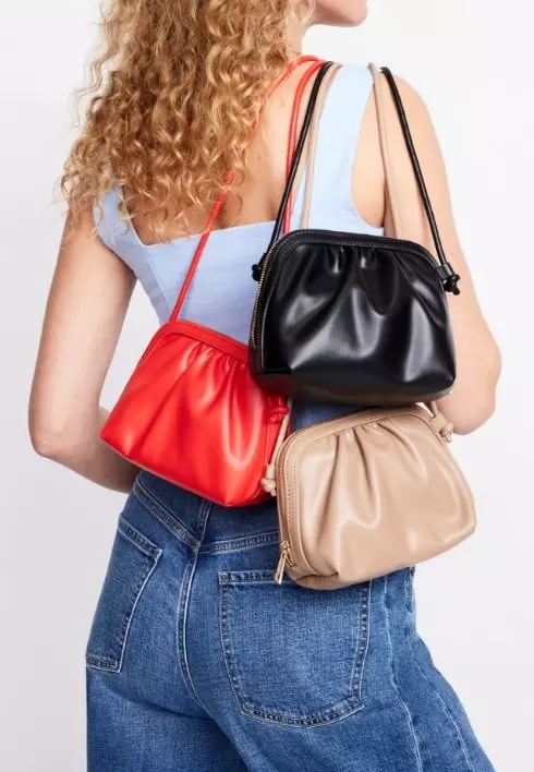 Image of a female model wearing three crossbody bags.