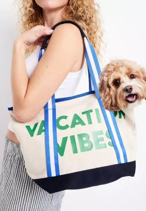 Image of a female model wearing a canvas tote back.