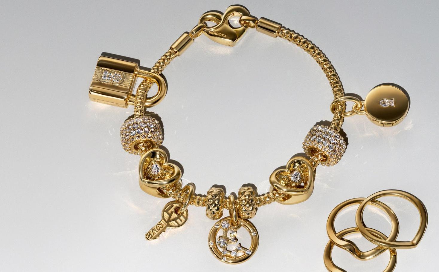 Image of pandora BE LOVE gold and lab diamond charm bracelet and five earrings