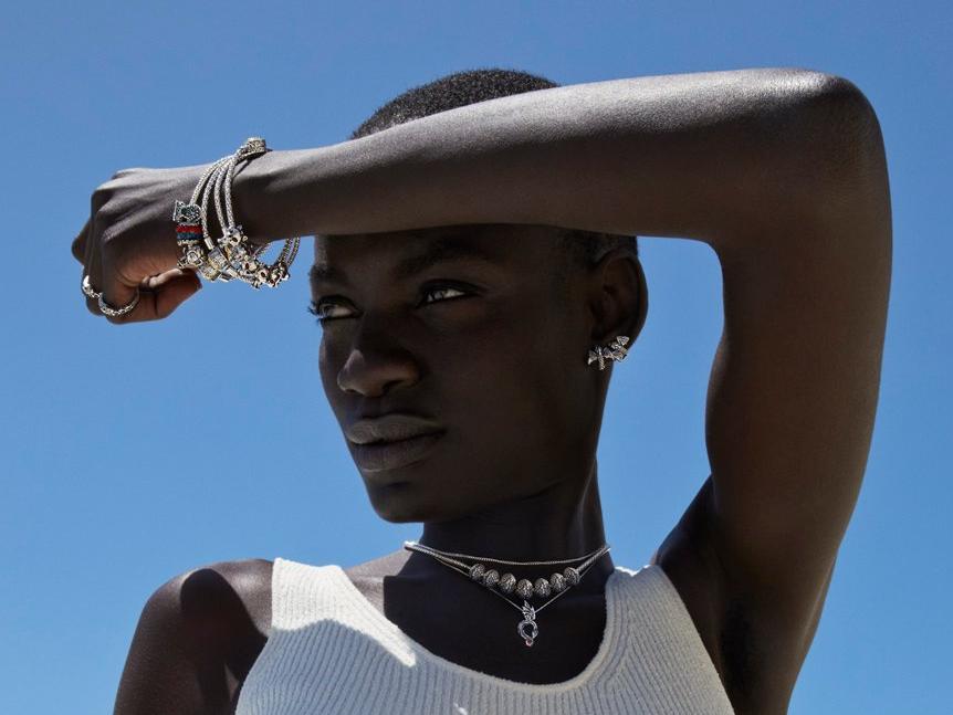 A woman in the sun, modelling Game of Thrones x Pandora jewellery.