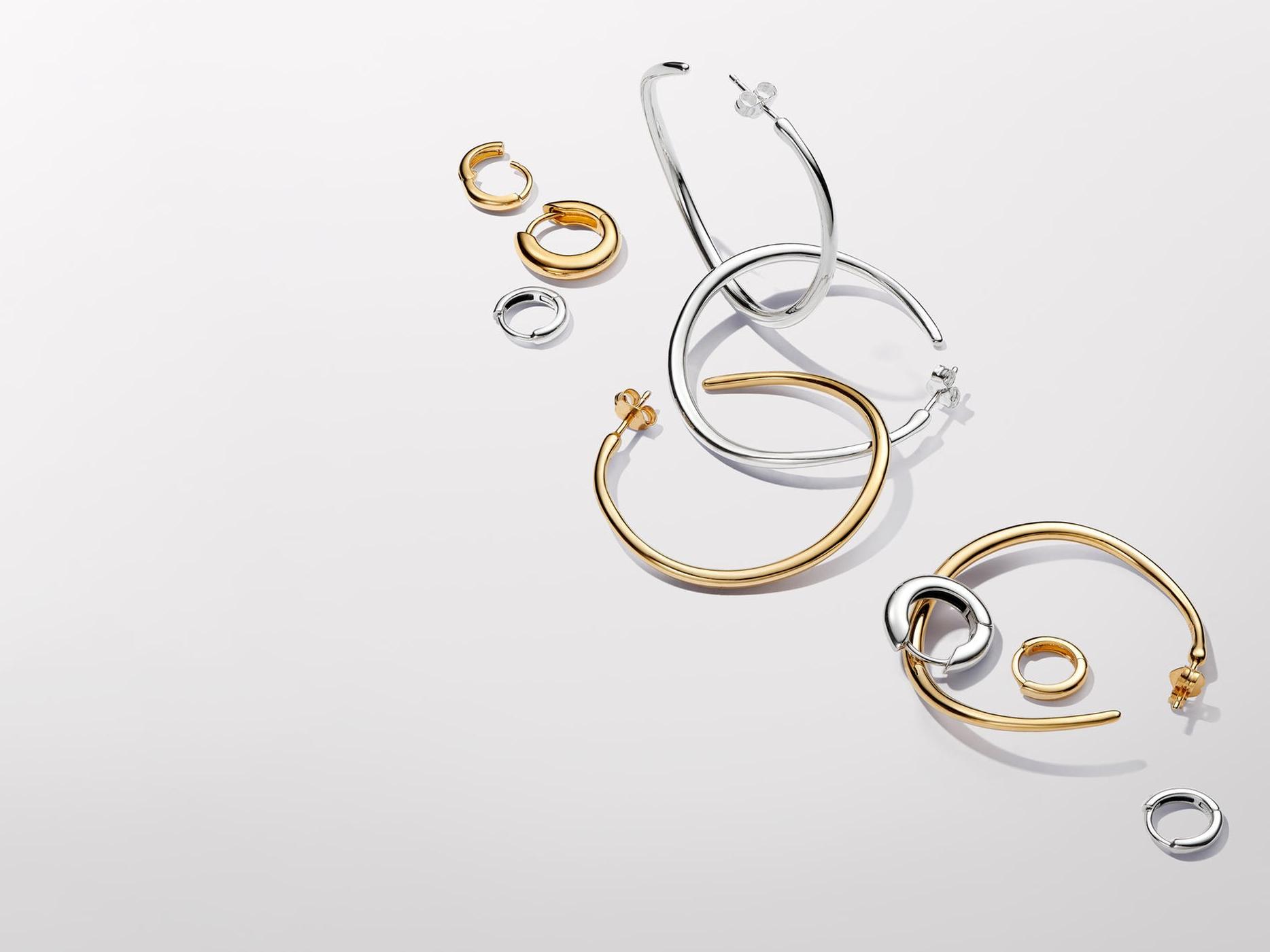 Pandora Essence gold and silver hoop earrings.