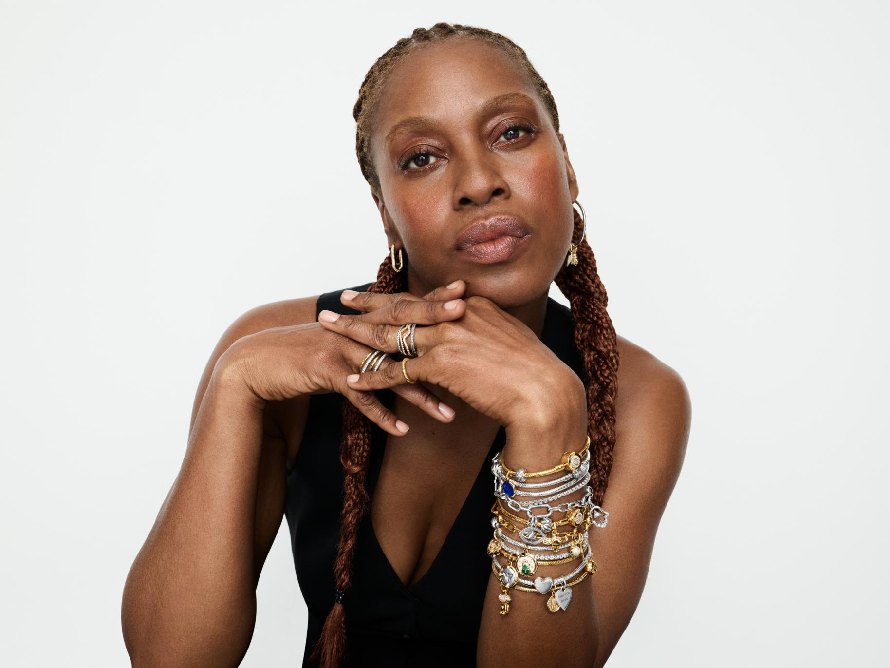 Susan Bender Whitfield, British Vogue's Creative Director, wears a charm bracelet stack, stacking rings and hoop earrings.