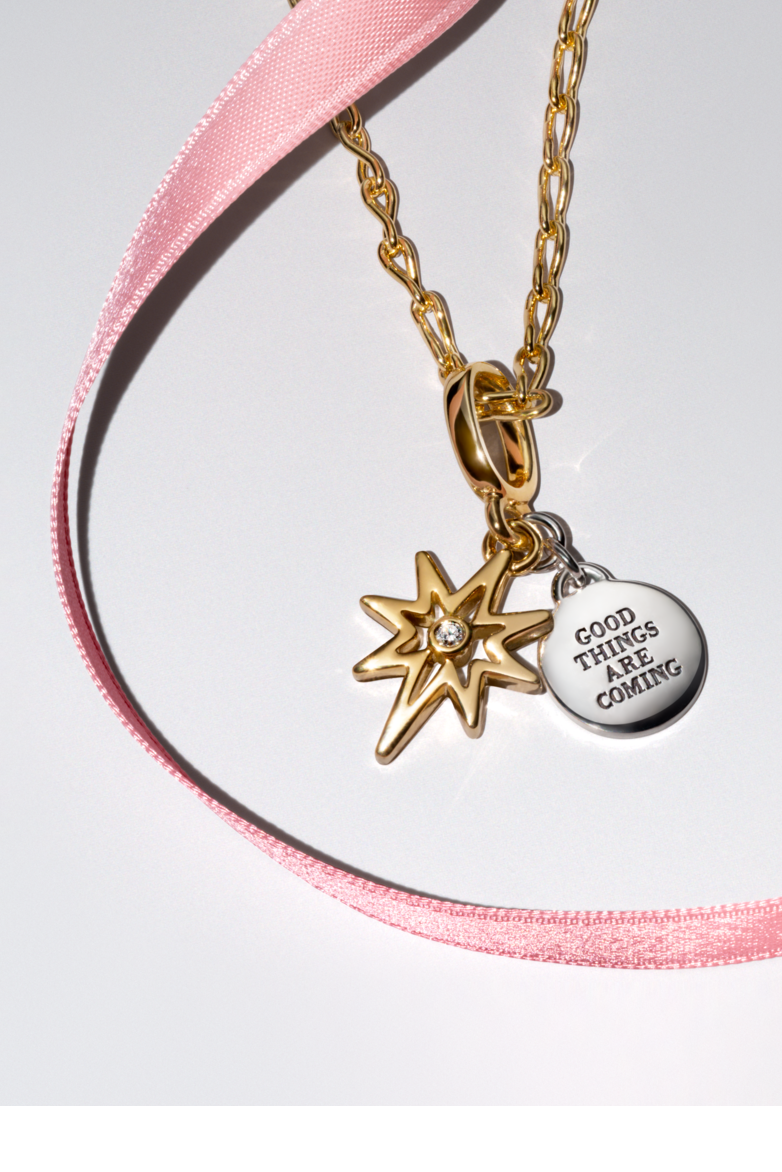 Halle and Chloe Bailey wear a gold and silver bracelet stack, gold pendant necklaces and a charm bracelet.