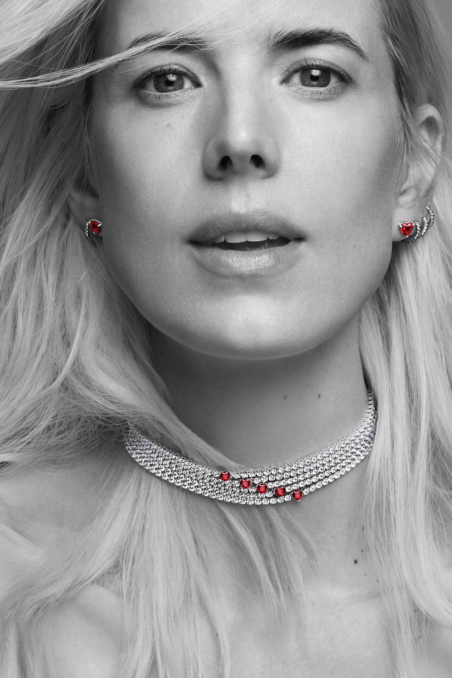 Model wears a sparkling choker necklace with stud earrings, and small hoops layered on left ear.