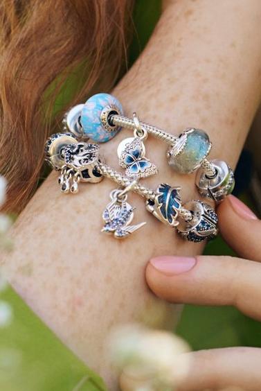 Model wearing Pandora Moments spring charm bracelets with flowers