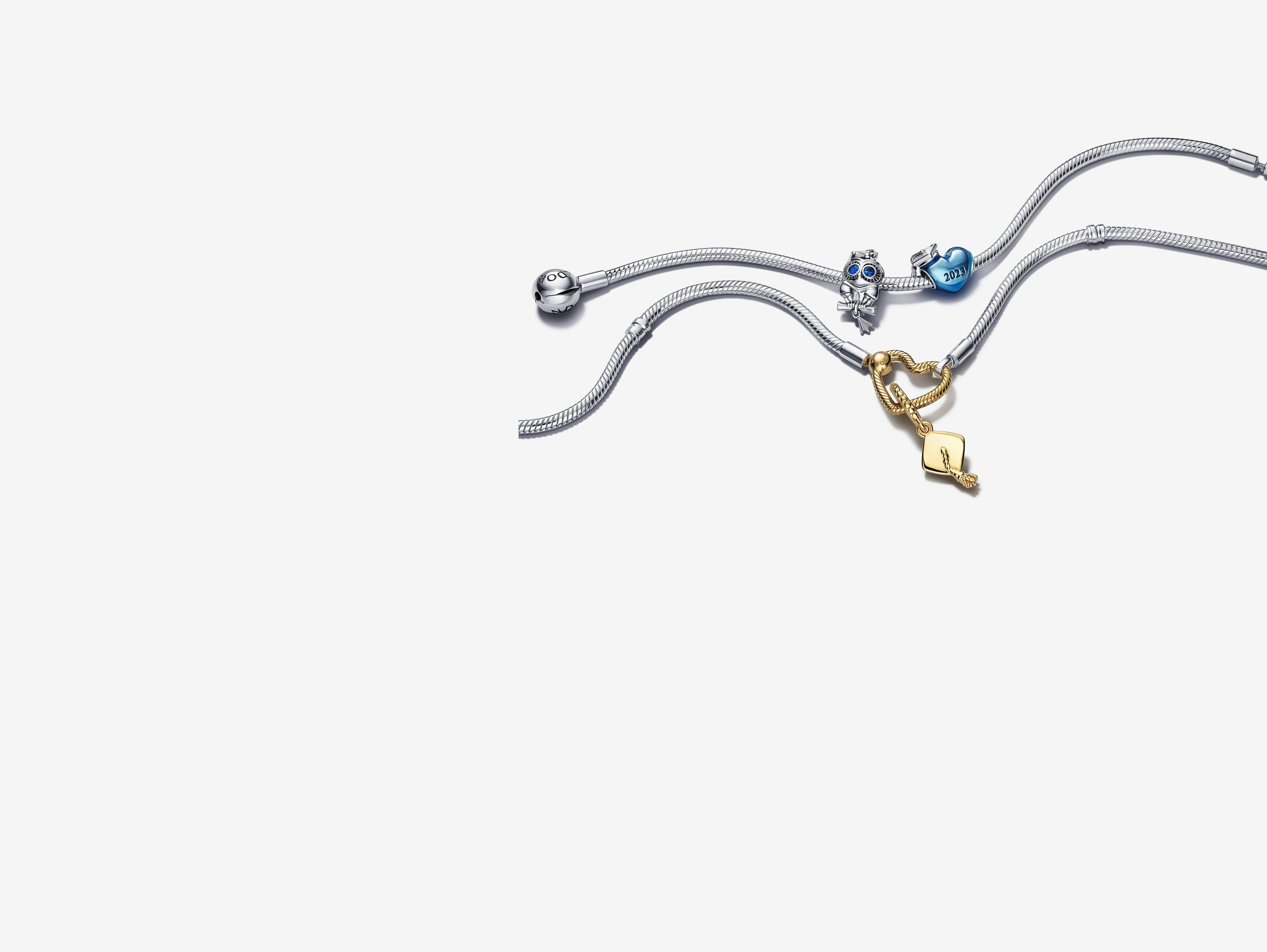 Two silver charm bracelets, with 3 silver, blue and gold achievement charms