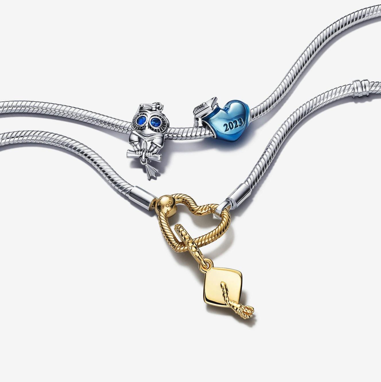 Two silver charm bracelets, with 3 silver, blue and gold achievement charms