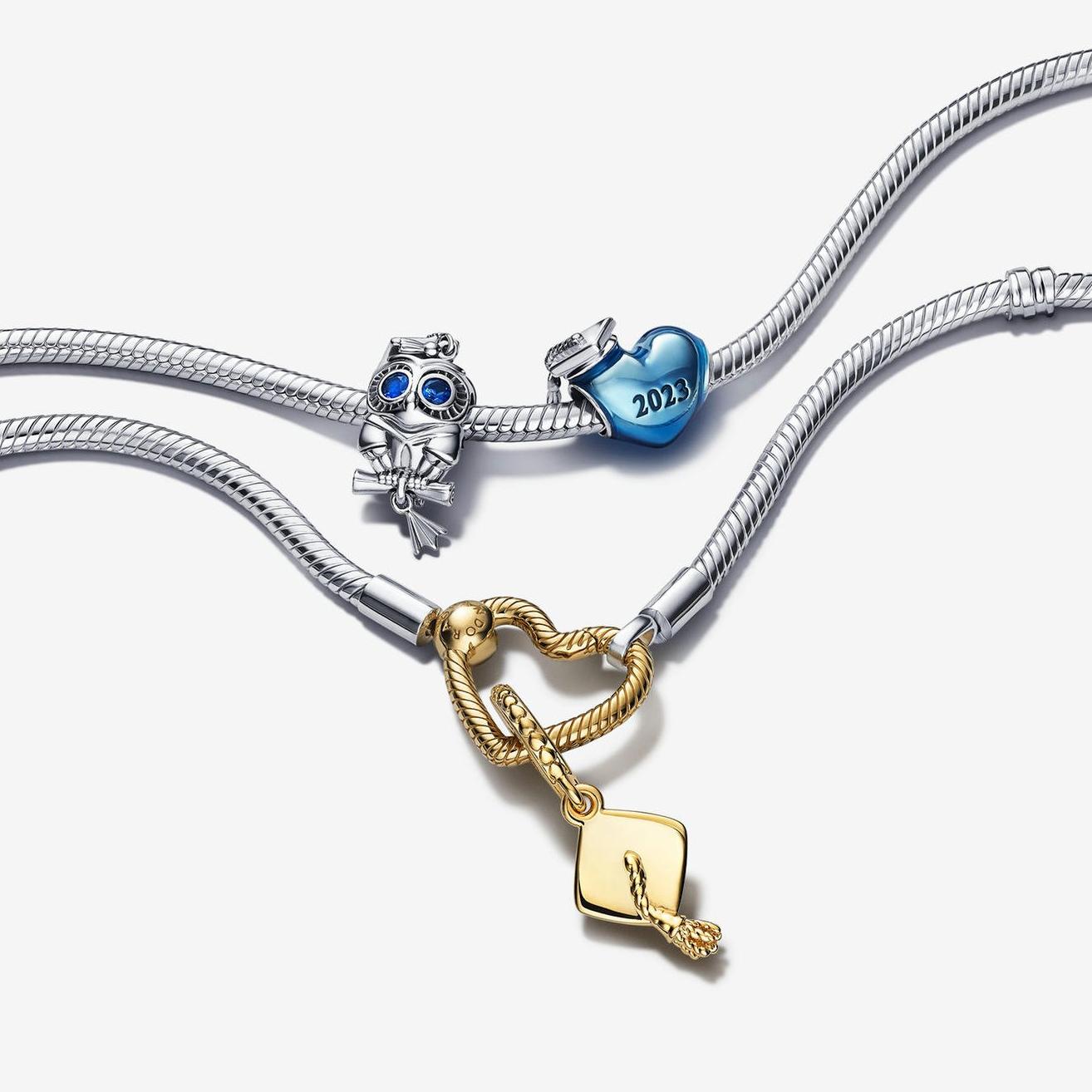 Two silver charm bracelets, with 3 silver, blue and gold achievement charms