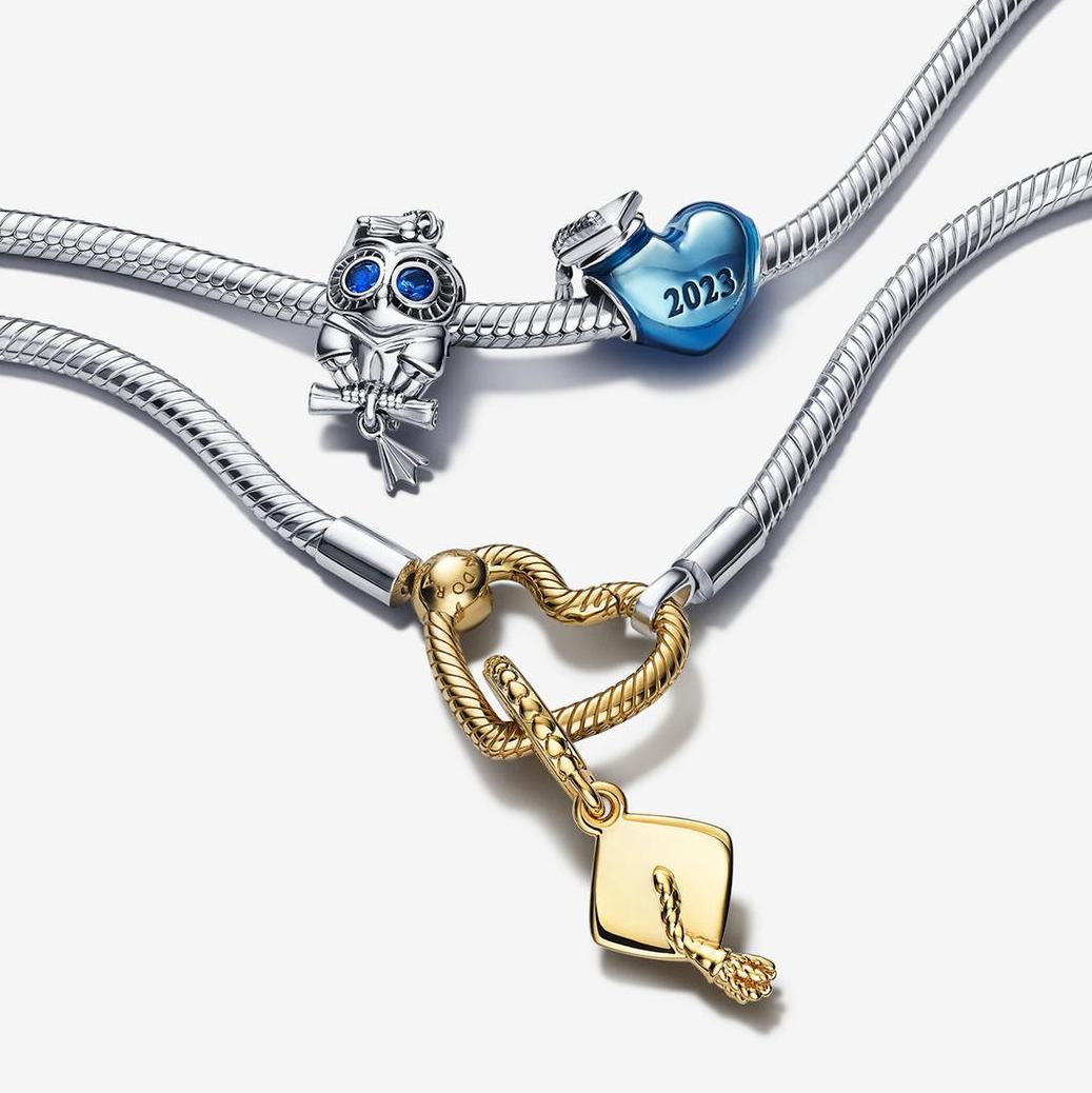 Two silver charm bracelets, with 3 silver, blue and gold achievement charms