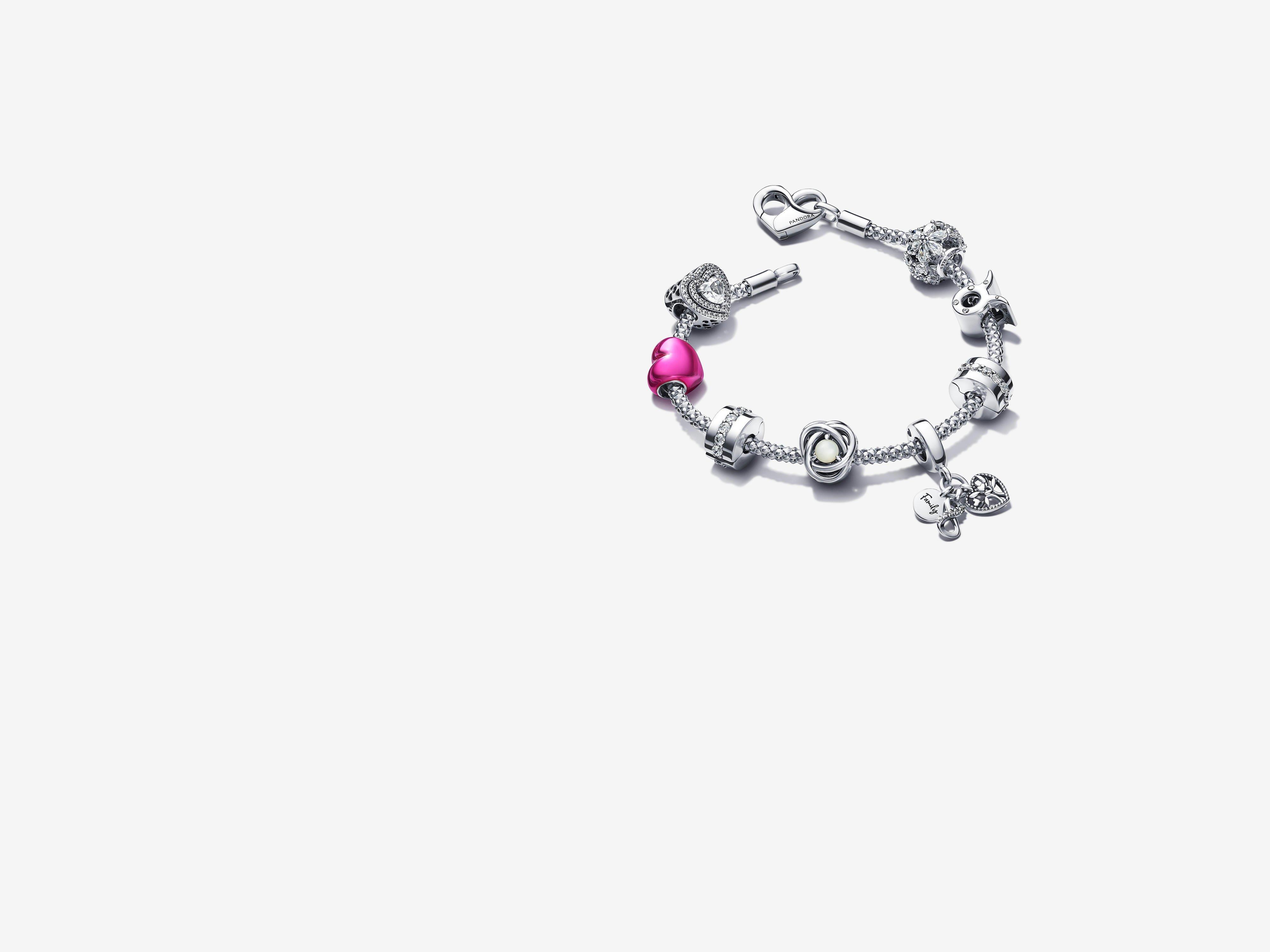 A silver bracelet and nine charms from the Just Because occasion collection