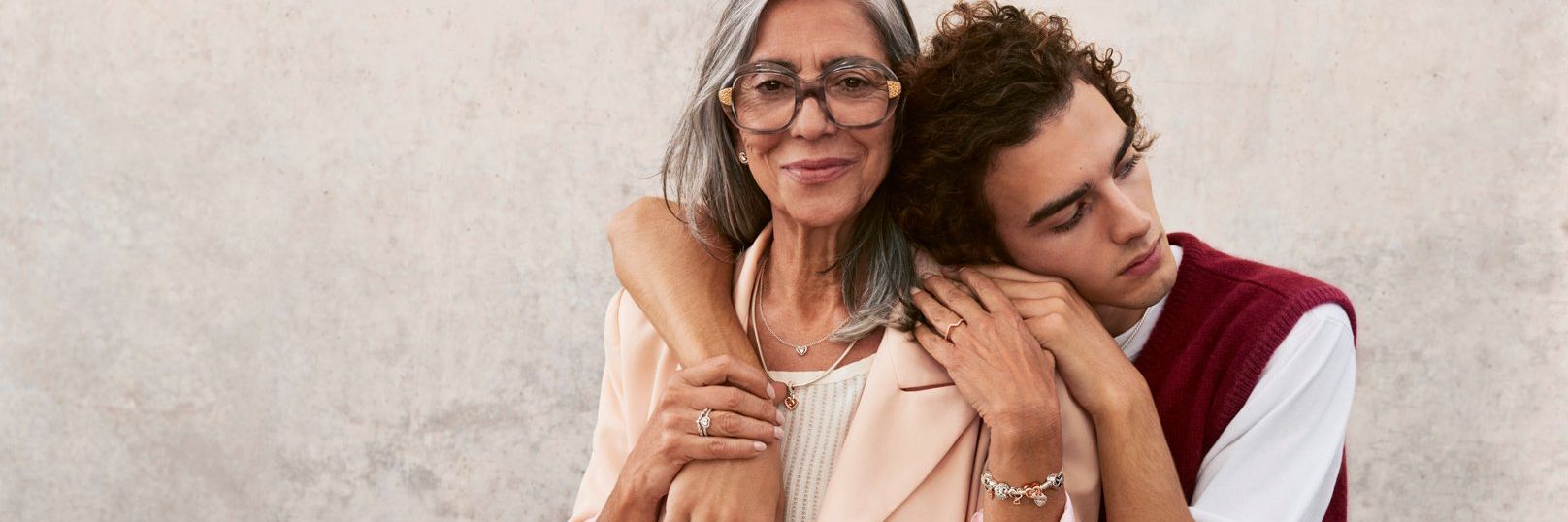 Son embraces mother who is wearing Pandora Mother's Day jewellery