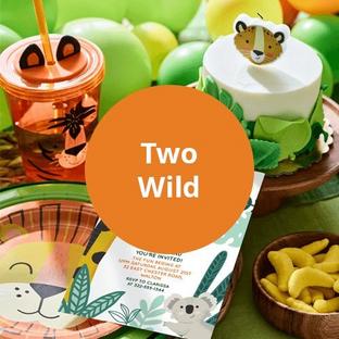 Two Wild Theme - Assortment of jungle party supplies including a tiger cup, disposable plates shaped like a lion, invitations adn a birthday cake.