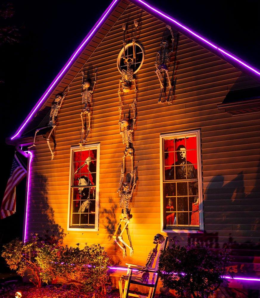 Skeletons climbing the side of the house