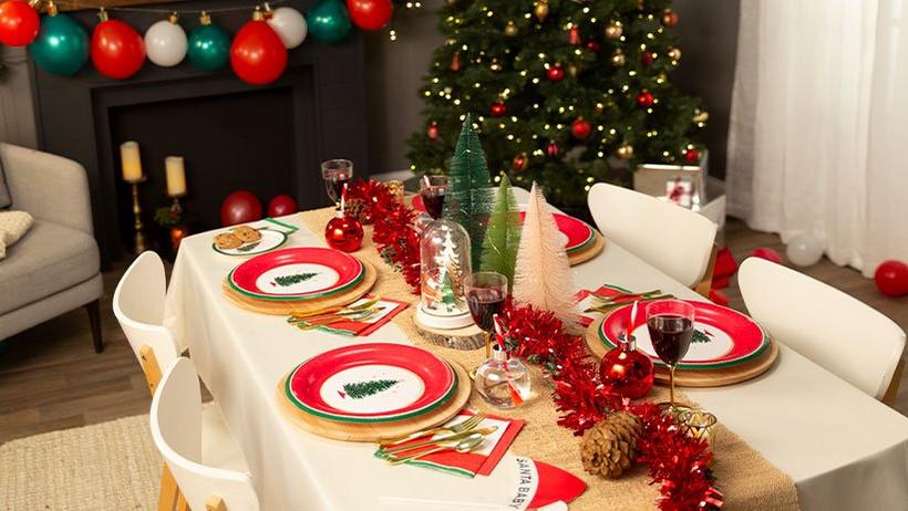 Festive holiday table decorated with evergreen tree plates red lighted garland and so much more