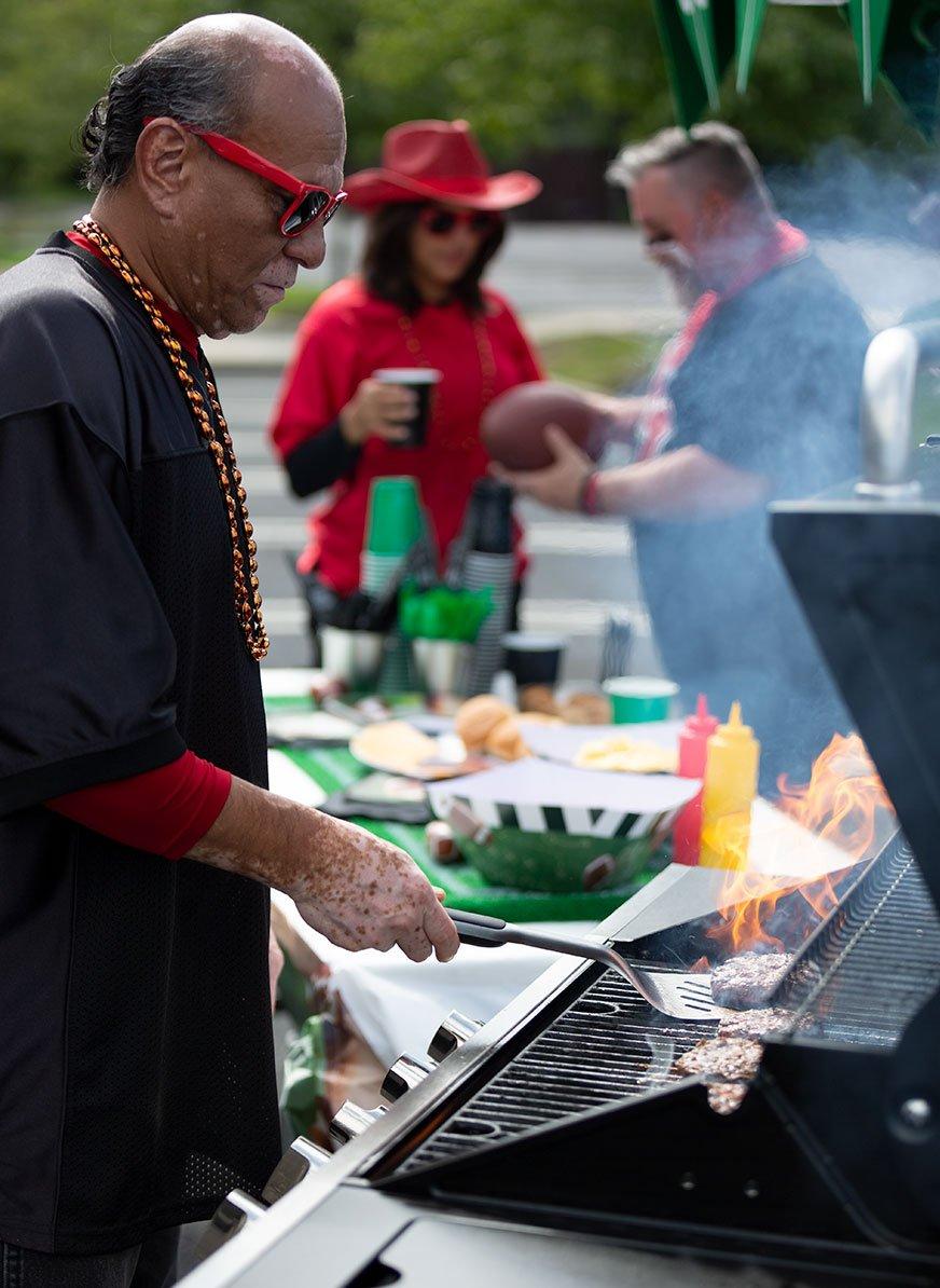 Man grilling at a tailgate party