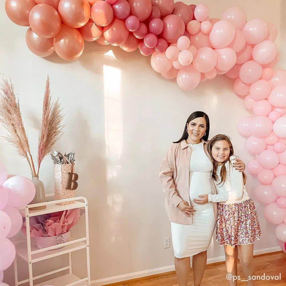 A balloon garland cascades down a wall.