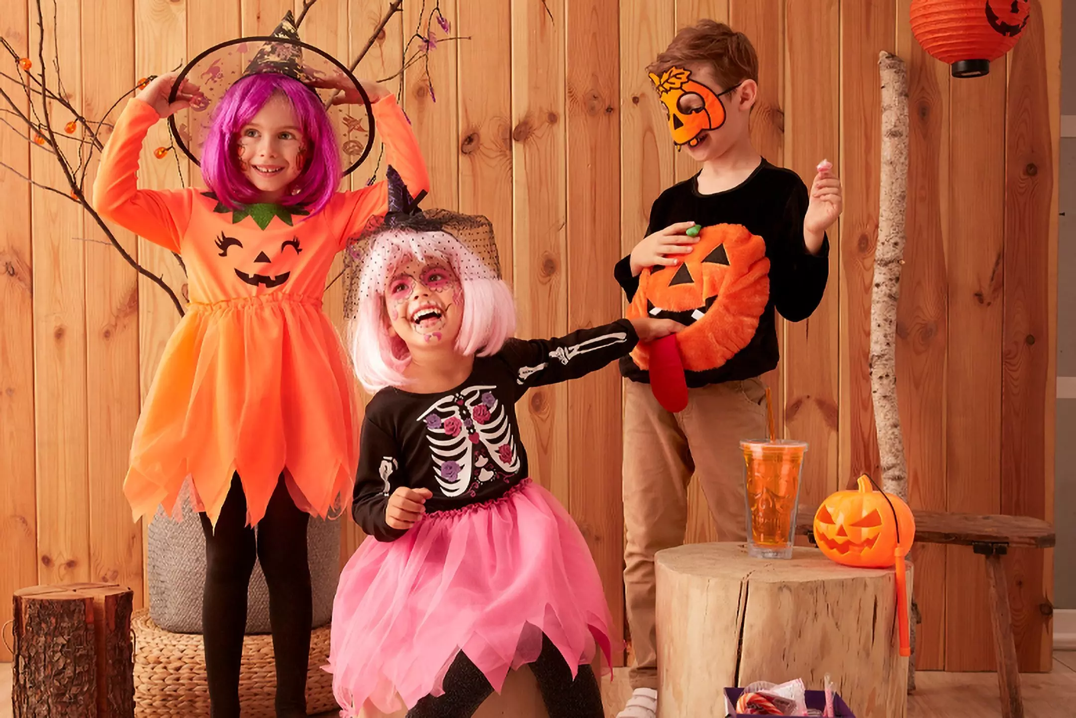 Children wearing Pepco Halloween costumes including pumpkin dress, skeleton outfit with tutu, and holding a plush pumpkin.