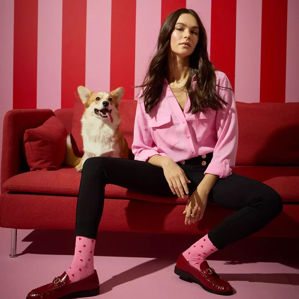 Pepco bedroom set featuring floral bedding, matching cushions, and ottoman stool with pink peony pattern in a sage green room.
