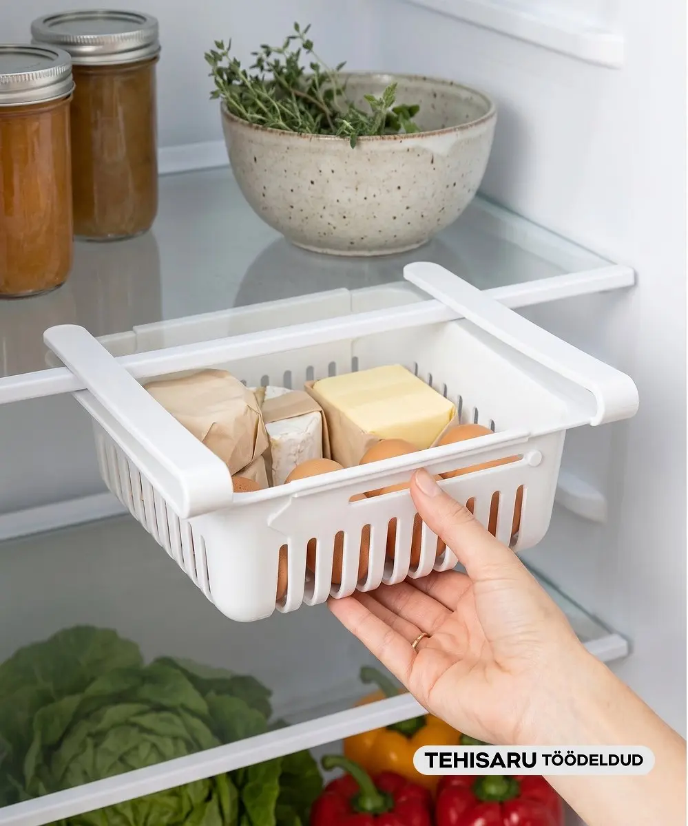 Pepco white sliding fridge drawer organiser being pulled out by hand, containing cheese and eggs.