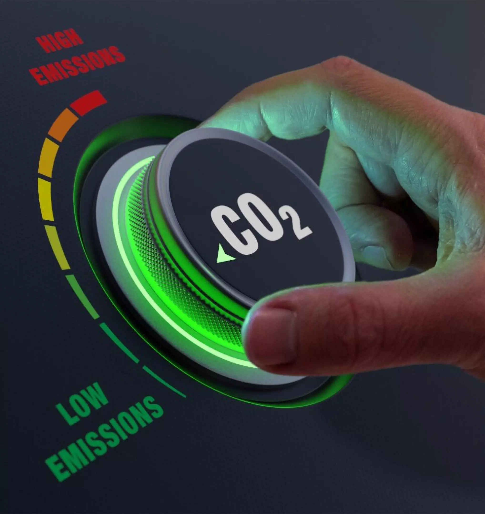 Hand adjusting a CO2 emissions dial from Pepco showing a green indicator for low emissions versus red for high emissions.