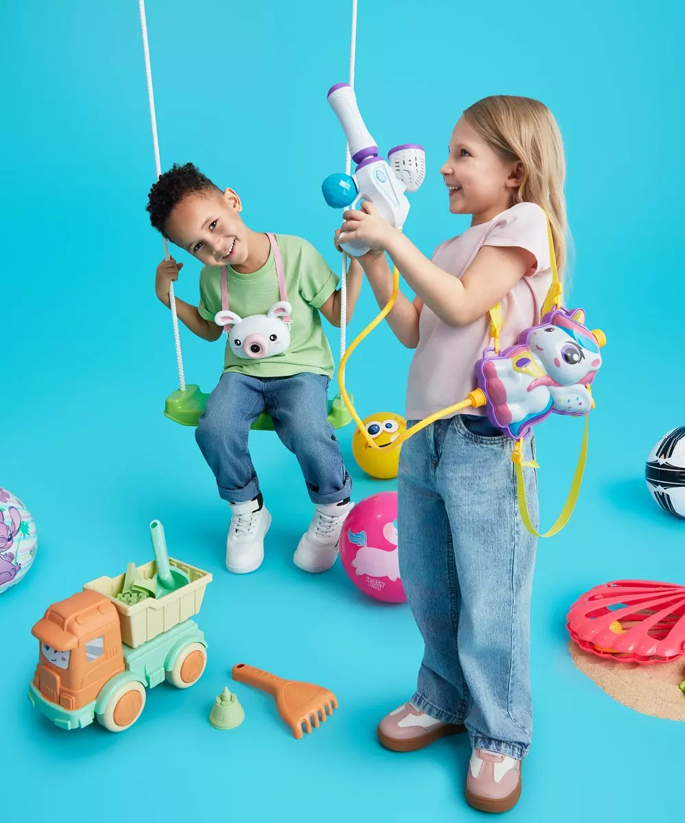 Two children playing with colourful outdoor toys including swings, fishing rods, and sand toys.