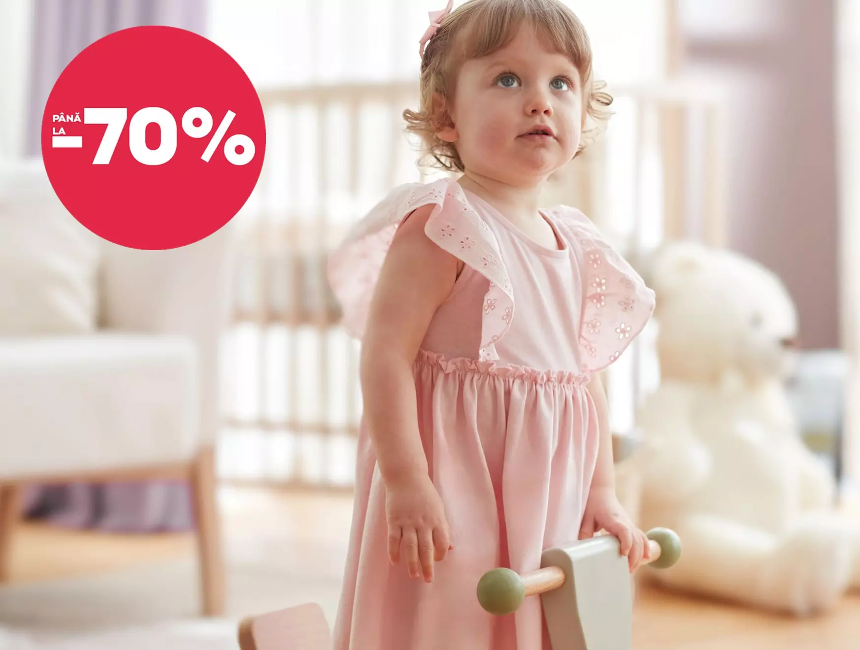 Fetiță în rochie roz Pepco cu reduceri până la 70%.