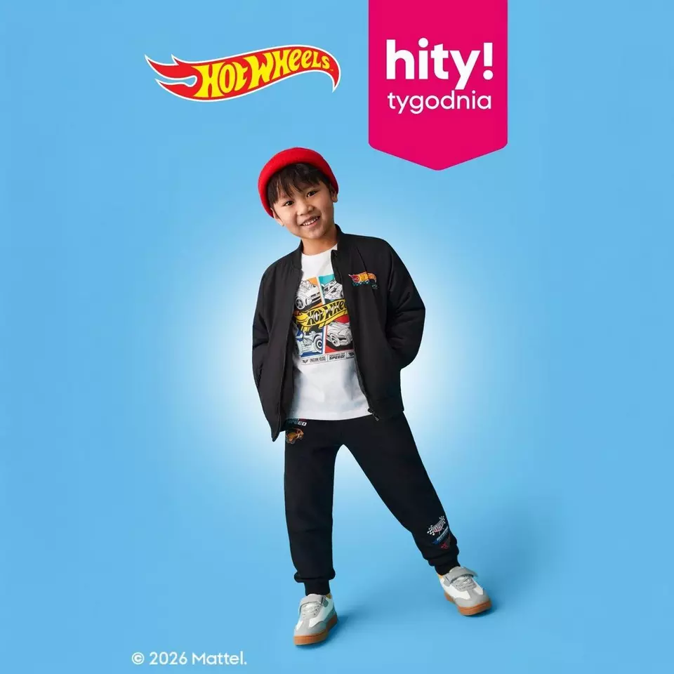 Dziecko w czerwonej czapce i ubraniach z motywem Hot Wheels, na niebieskim tle z logo marki i napisem "hity! tygodnia".