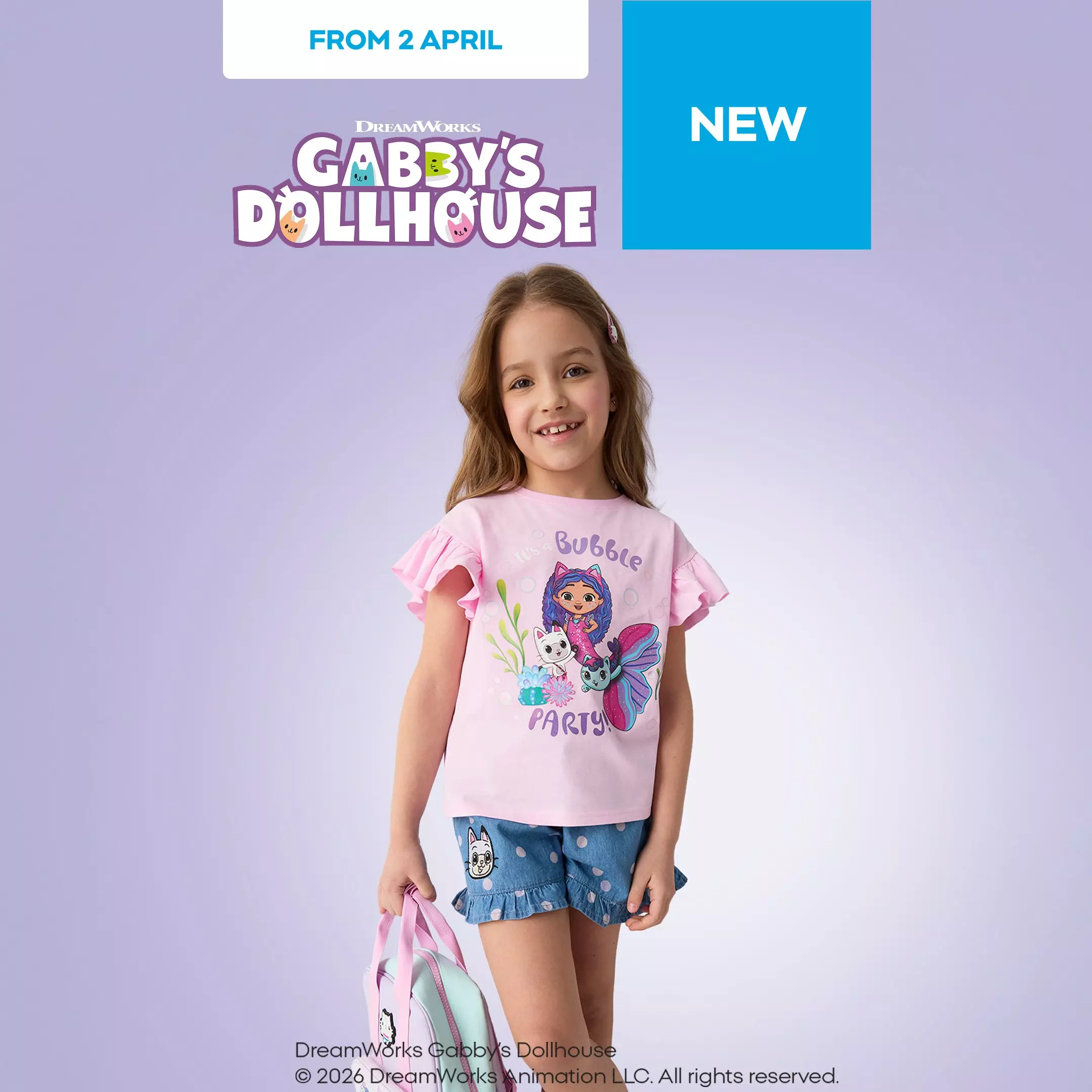 Girl wearing pink Gabby's Dollhouse t-shirt with Bubble Party graphic and denim shorts, smiling.