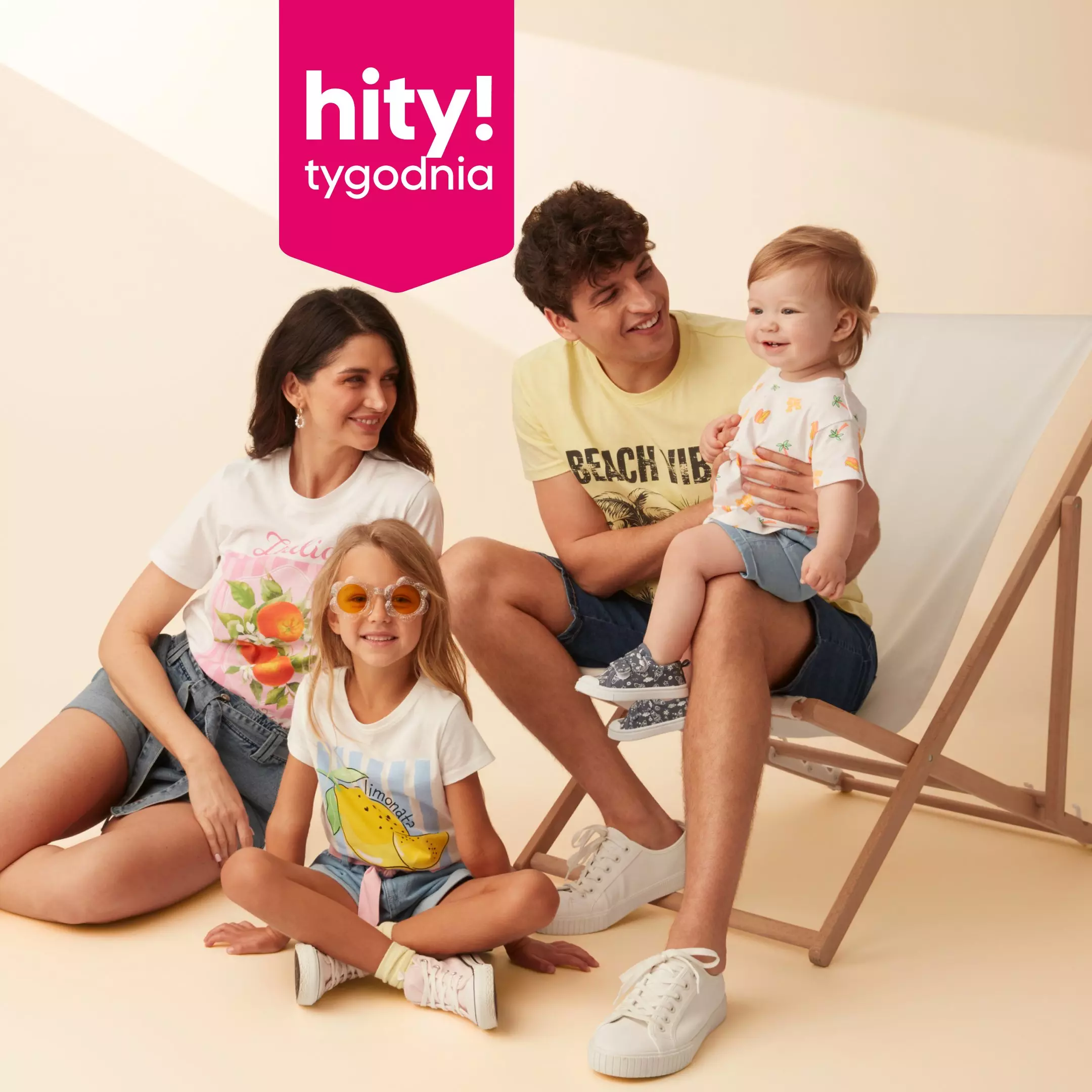 Rodzina w kolorowych koszulkach z nadrukami owocowymi, promująca tygodniową ofertę hity! tygodnia.