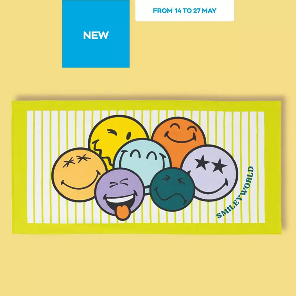 Yellow beach towel featuring SMILEYWORLD emoji faces with various expressions on white striped design.
