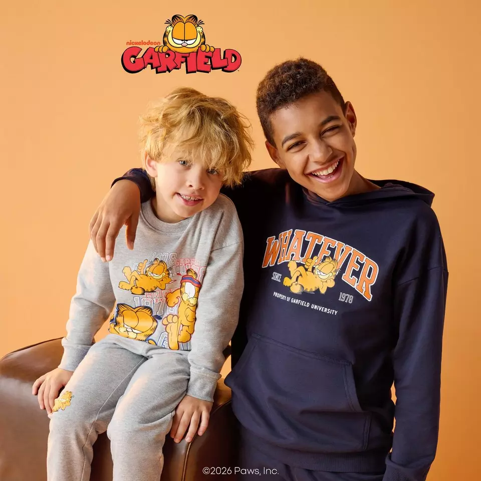 Doi băieți zâmbitori poartă îmbrăcăminte Pepco cu personajul Garfield de la Nickelodeon.