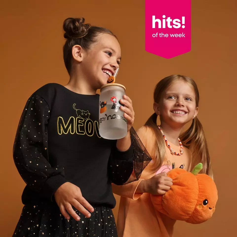 Pepco girls wearing Halloween outfits, one holding a water bottle and the other holding a pumpkin plush toy.