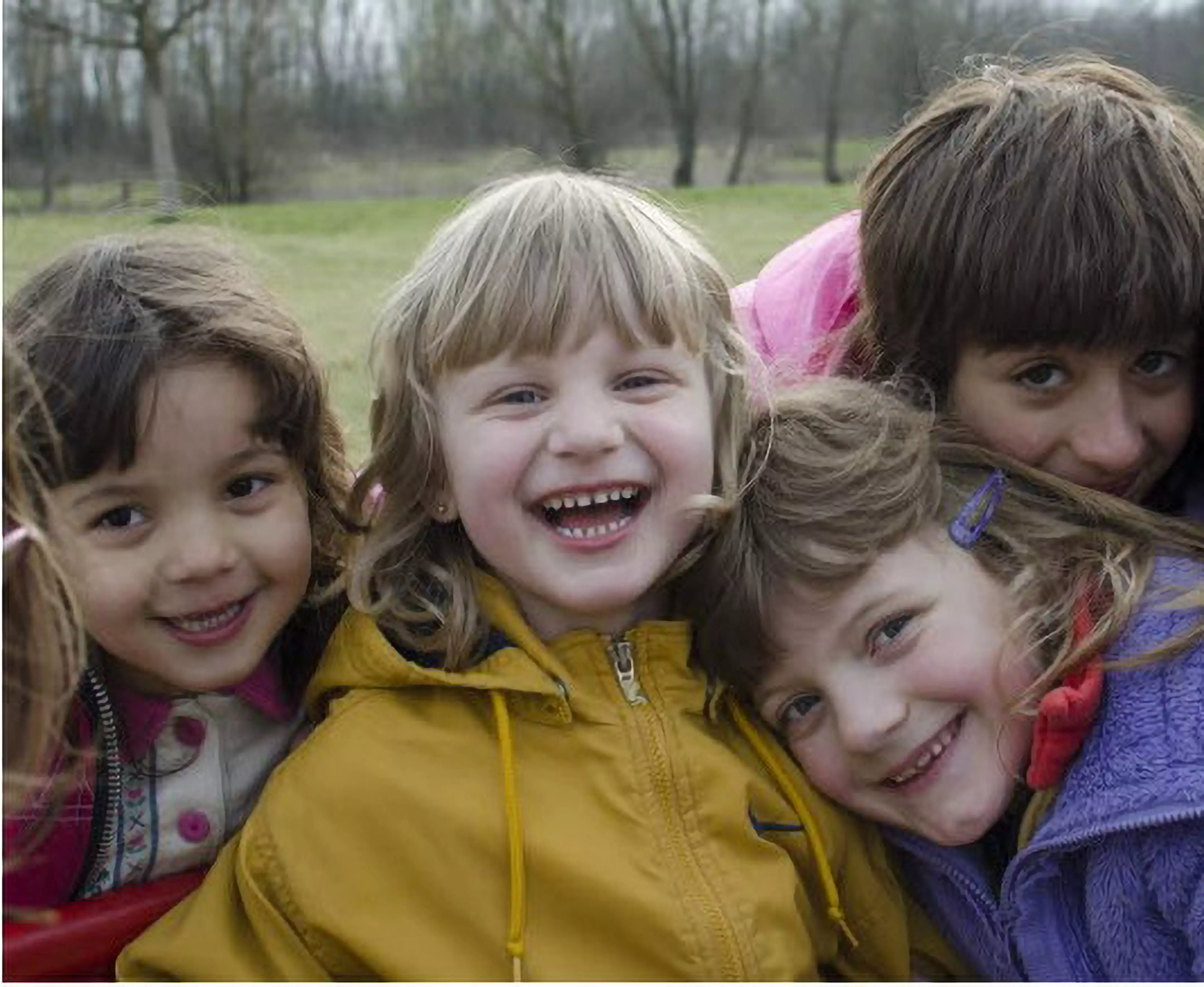 Children enjoying outdoor play wearing colorful Pepco jackets including yellow, purple, and pink styles.