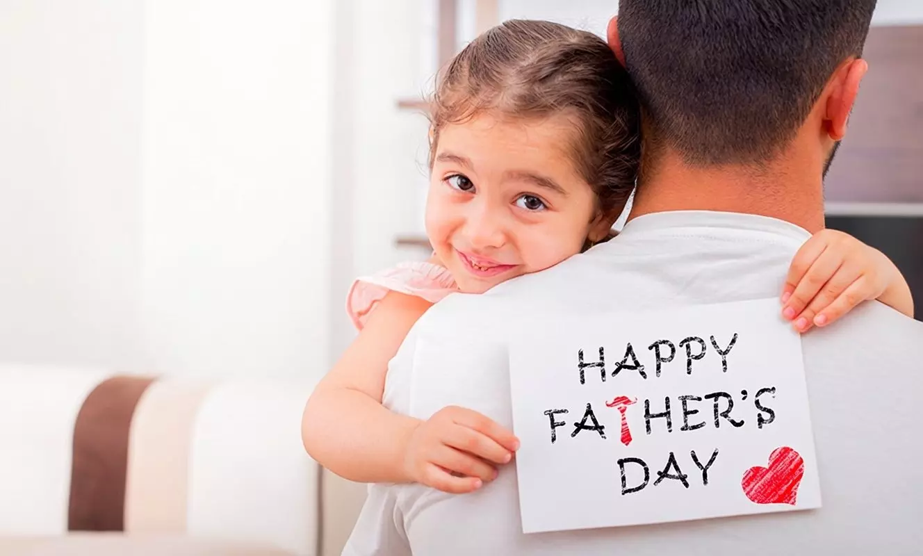 Child hugging adult wearing white shirt with HAPPY FATHER'S DAY sign from Pepco collection.