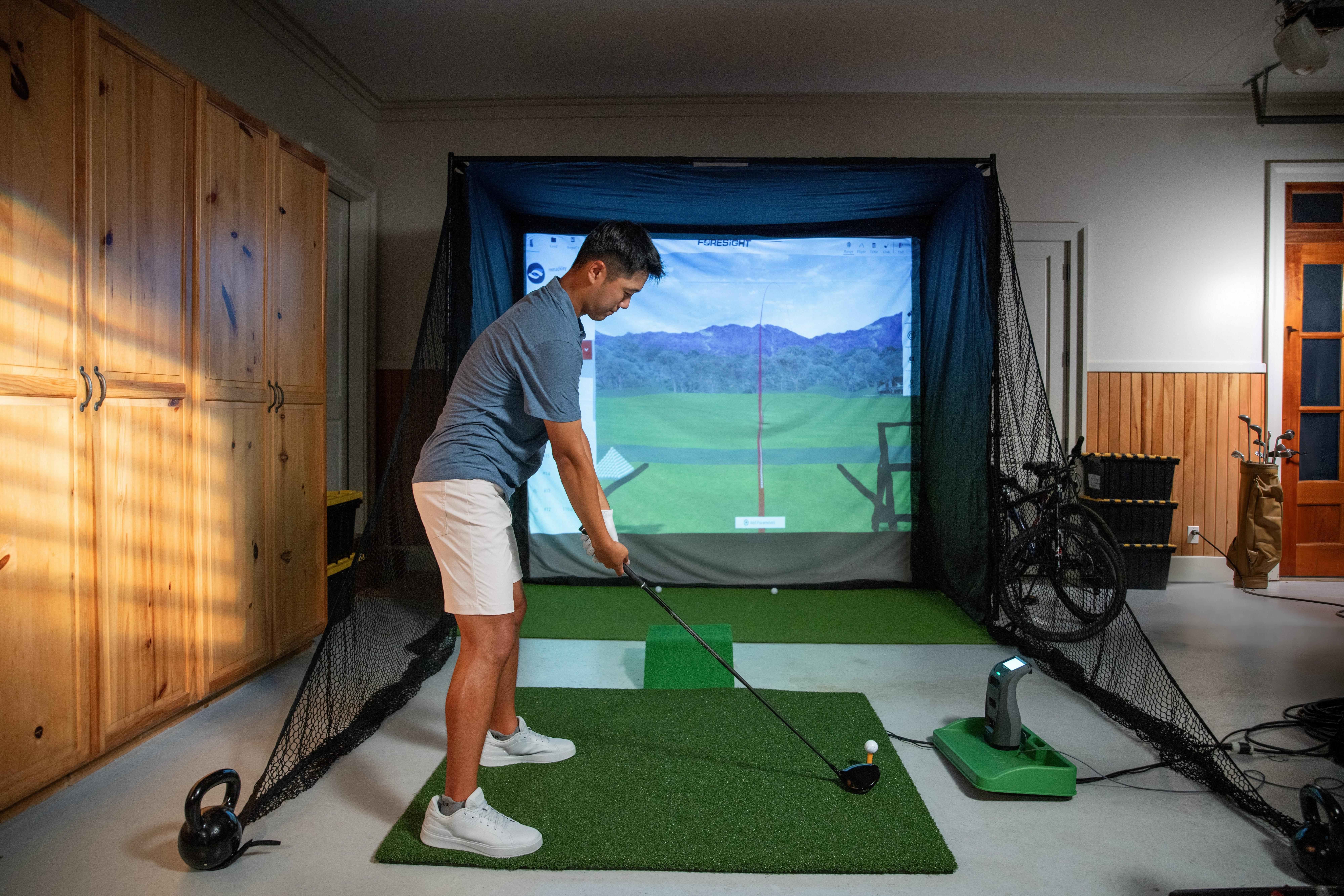 Golfer playing simulator monitor
