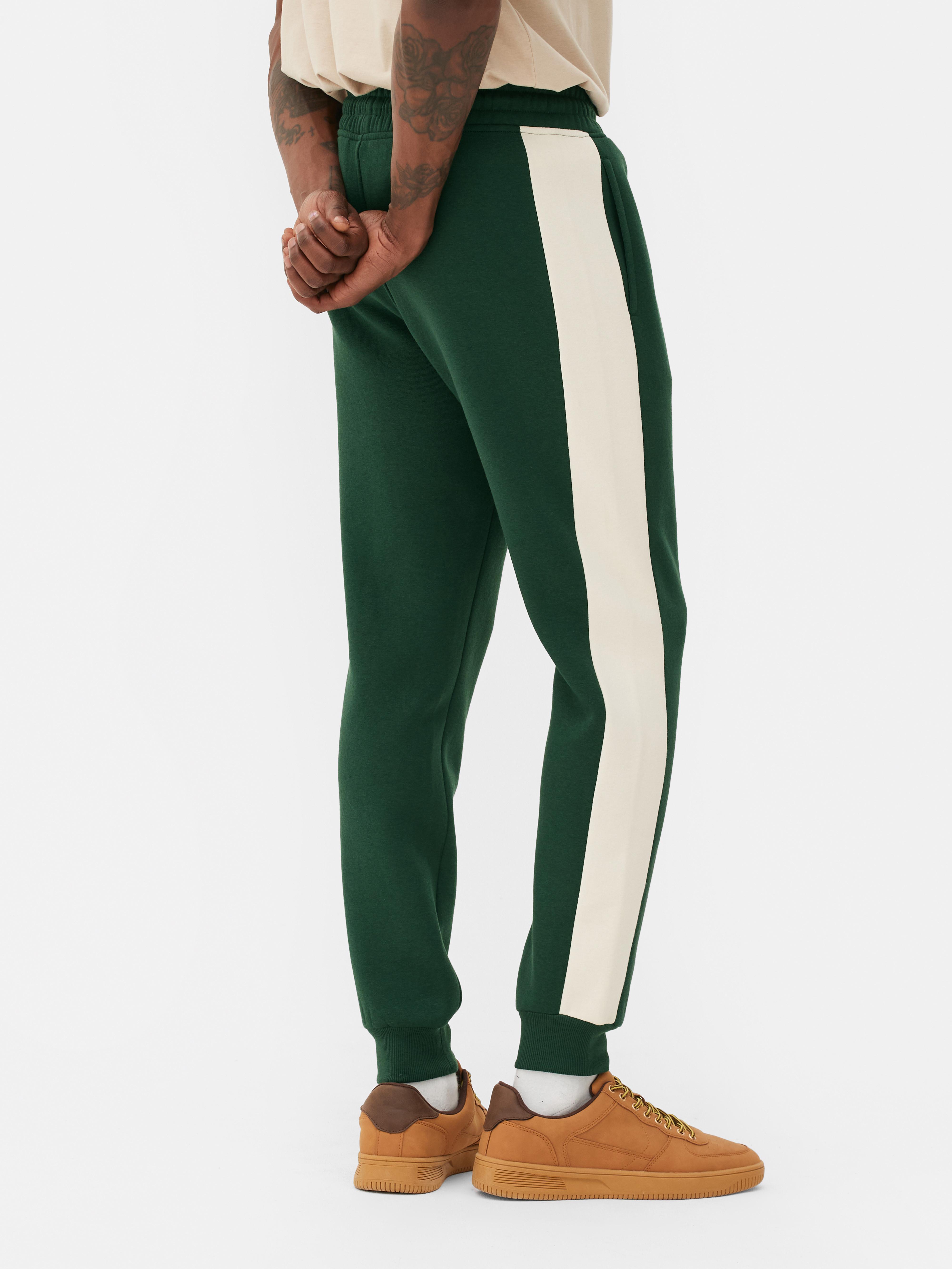 Green track pants with white online stripe