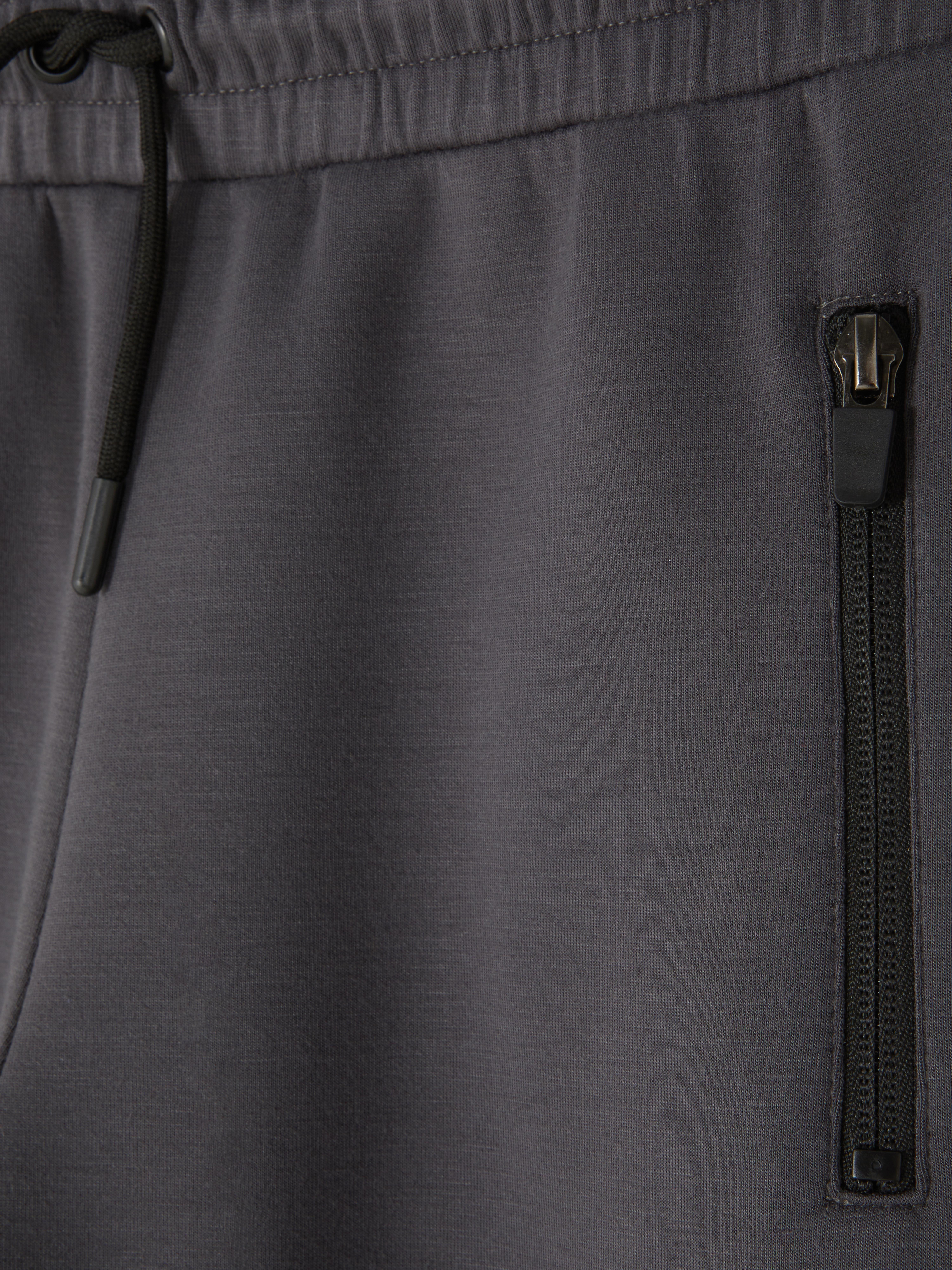 Pantaloni da tuta con tasca e zip
