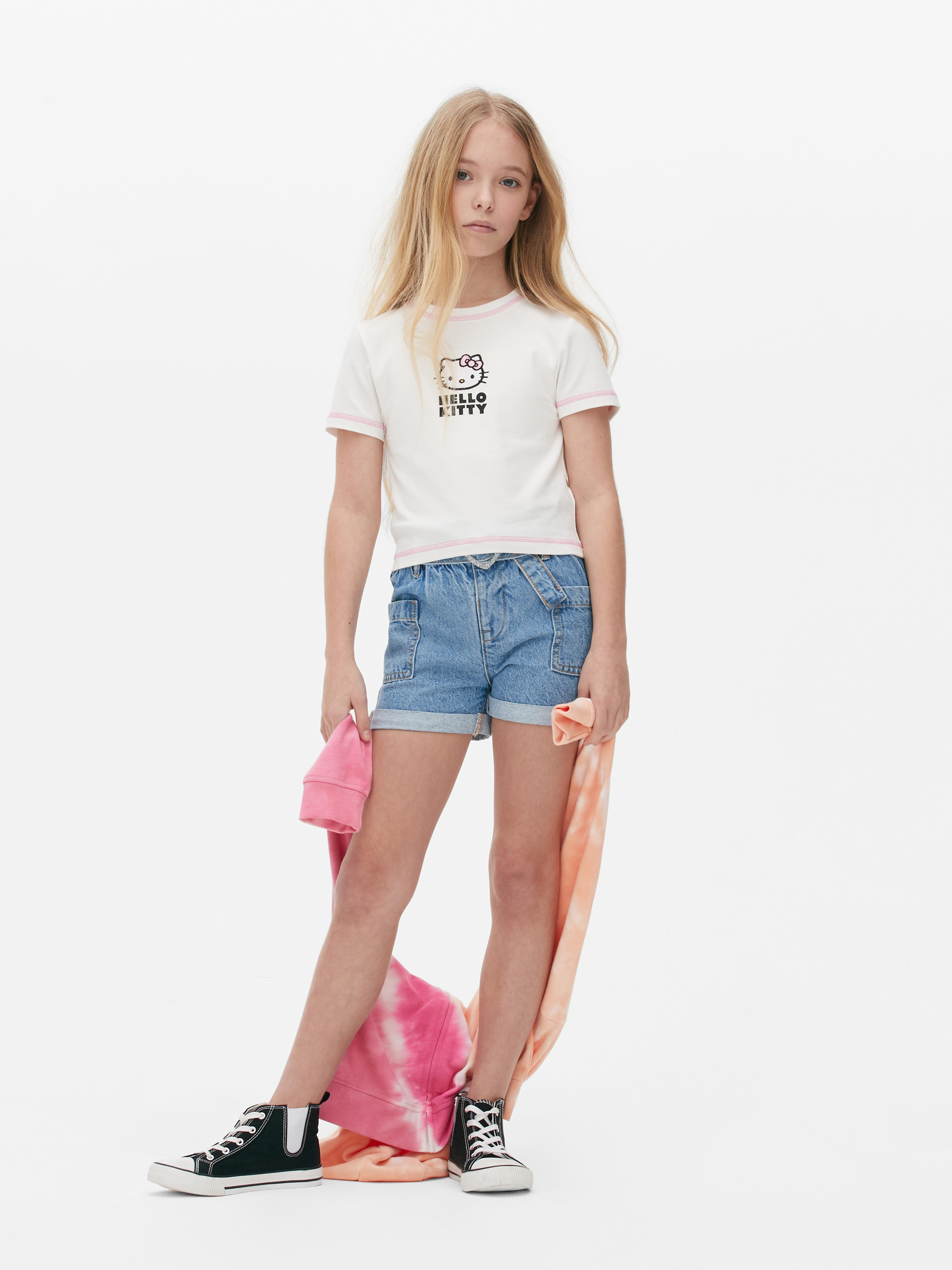 Little girl in a pure white t-shirt for advertising and shorts