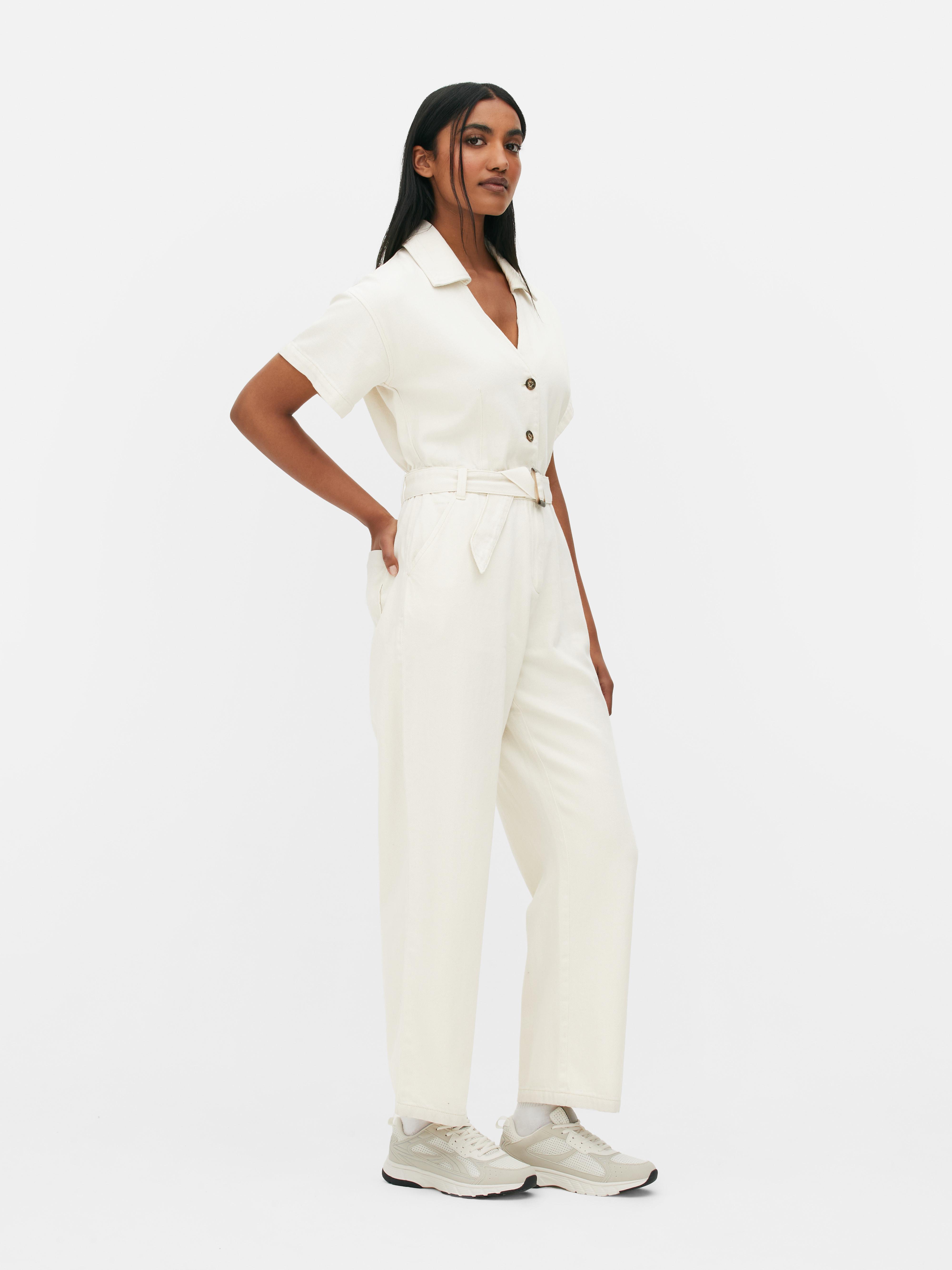 TOAST - CRINKLE COTTON JUMPSUIT  Soft, crinkled cotton double cloth with  high round neckline. Button opening at back and low drawstring waist - can  be worn low or tied. Ankle-skimming and