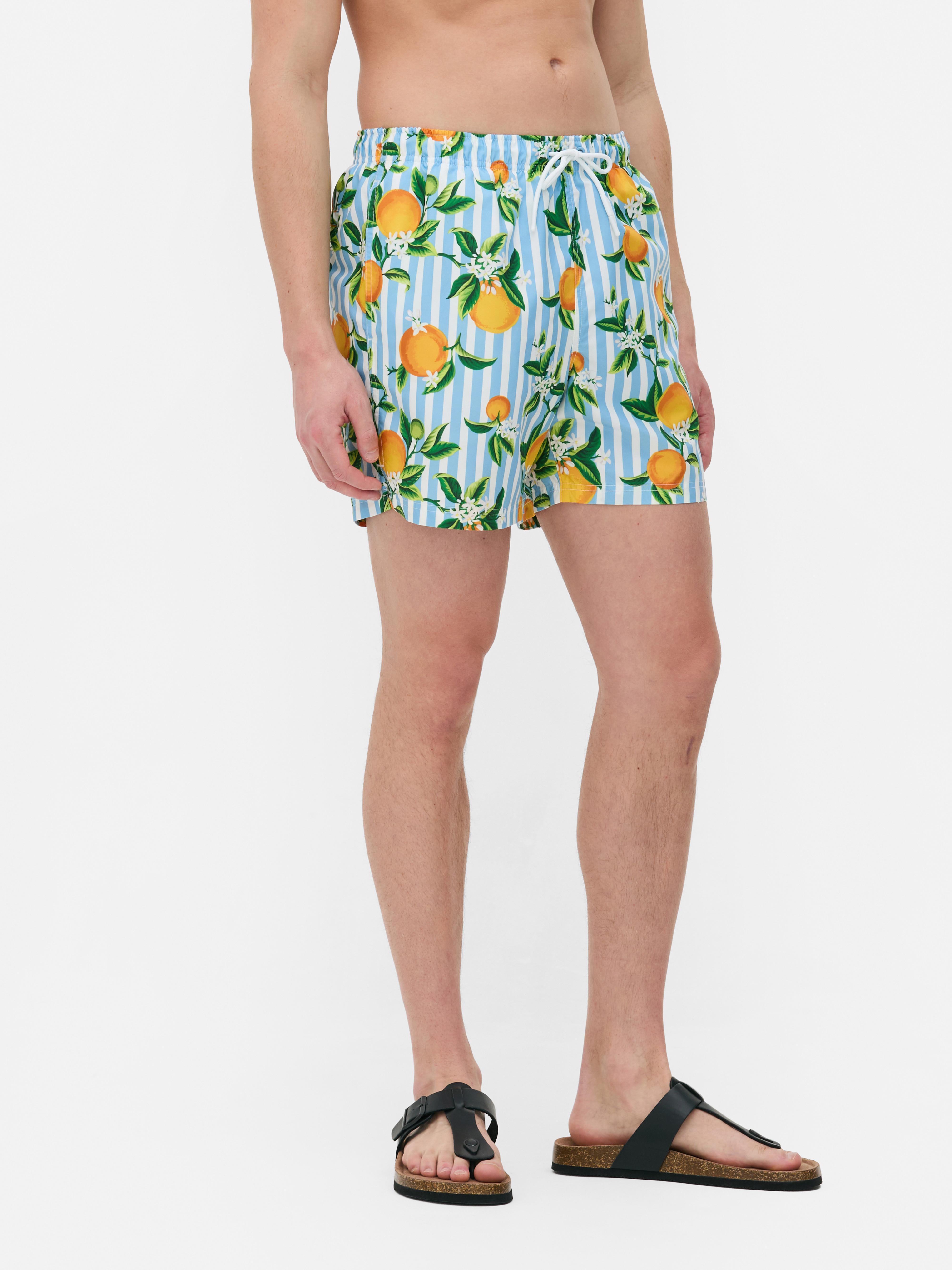 Badeshorts mit Streifen- und Orangenmuster