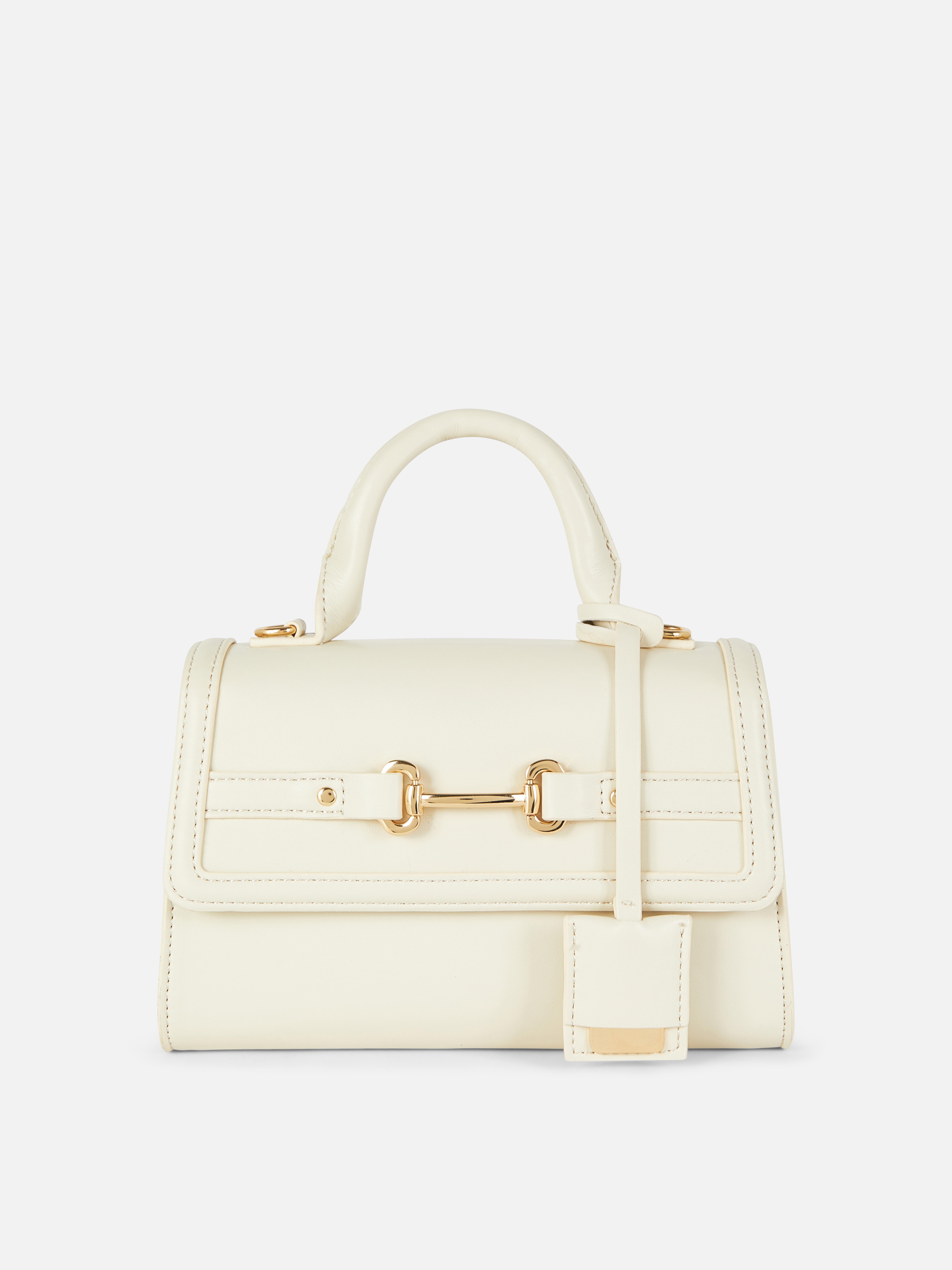Bolso con asa superior y hebilla tipo bocado de caballo