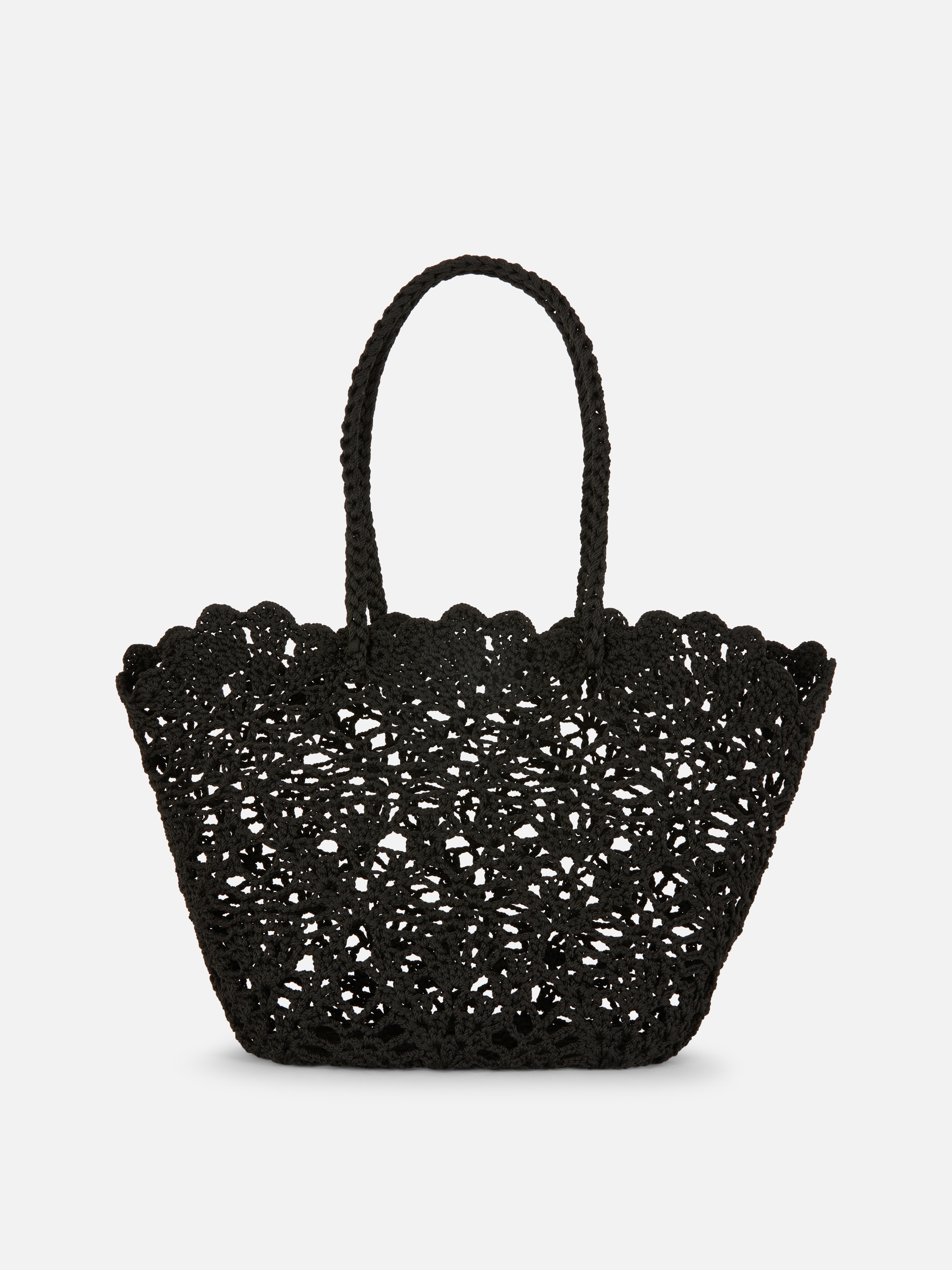 Paula Echevarría Crochet Bucket Bag A crochet-style bucket bag with braided carry handles and scallop trims