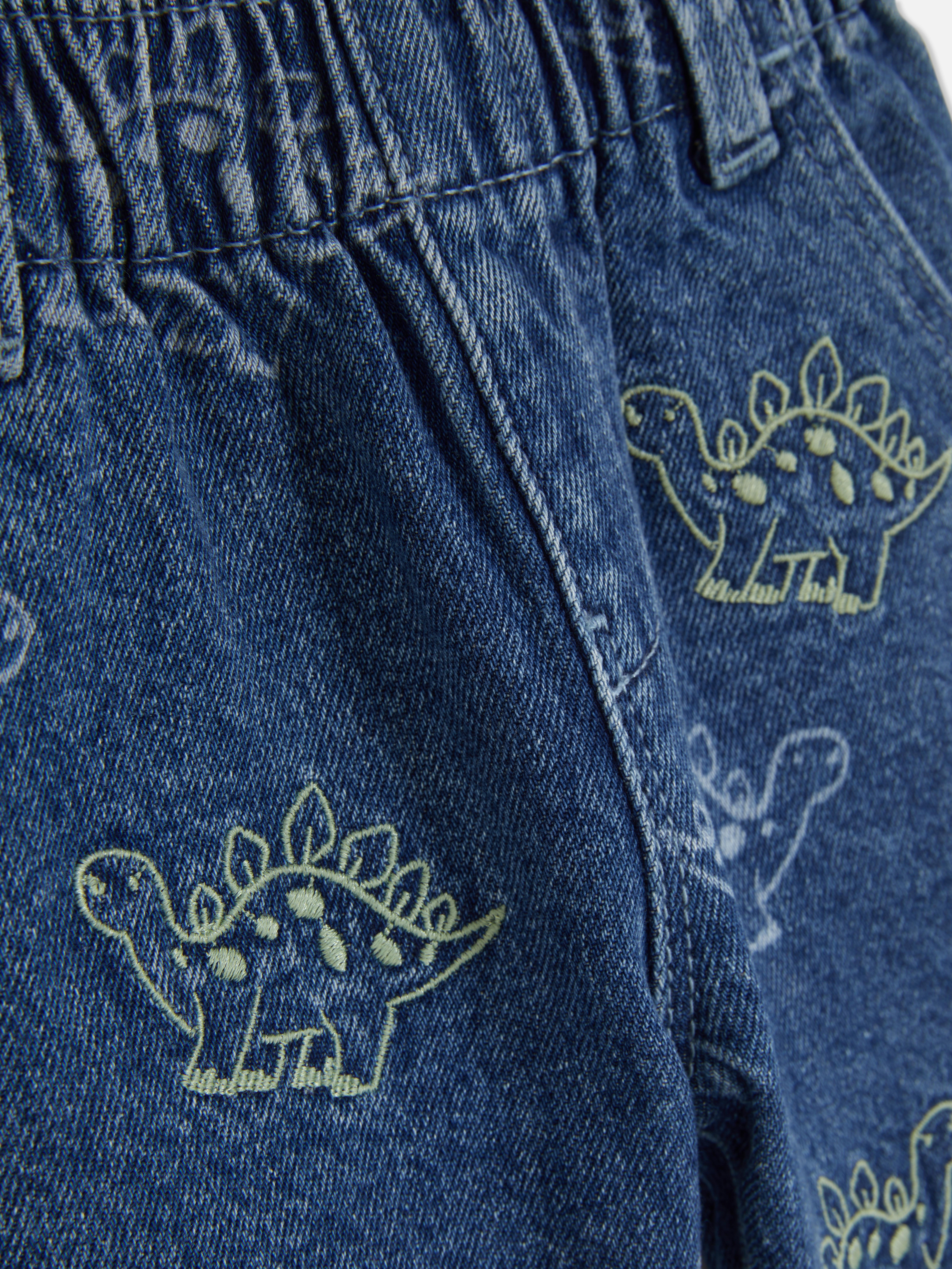 Jean en denim brodé à motif dinosaures