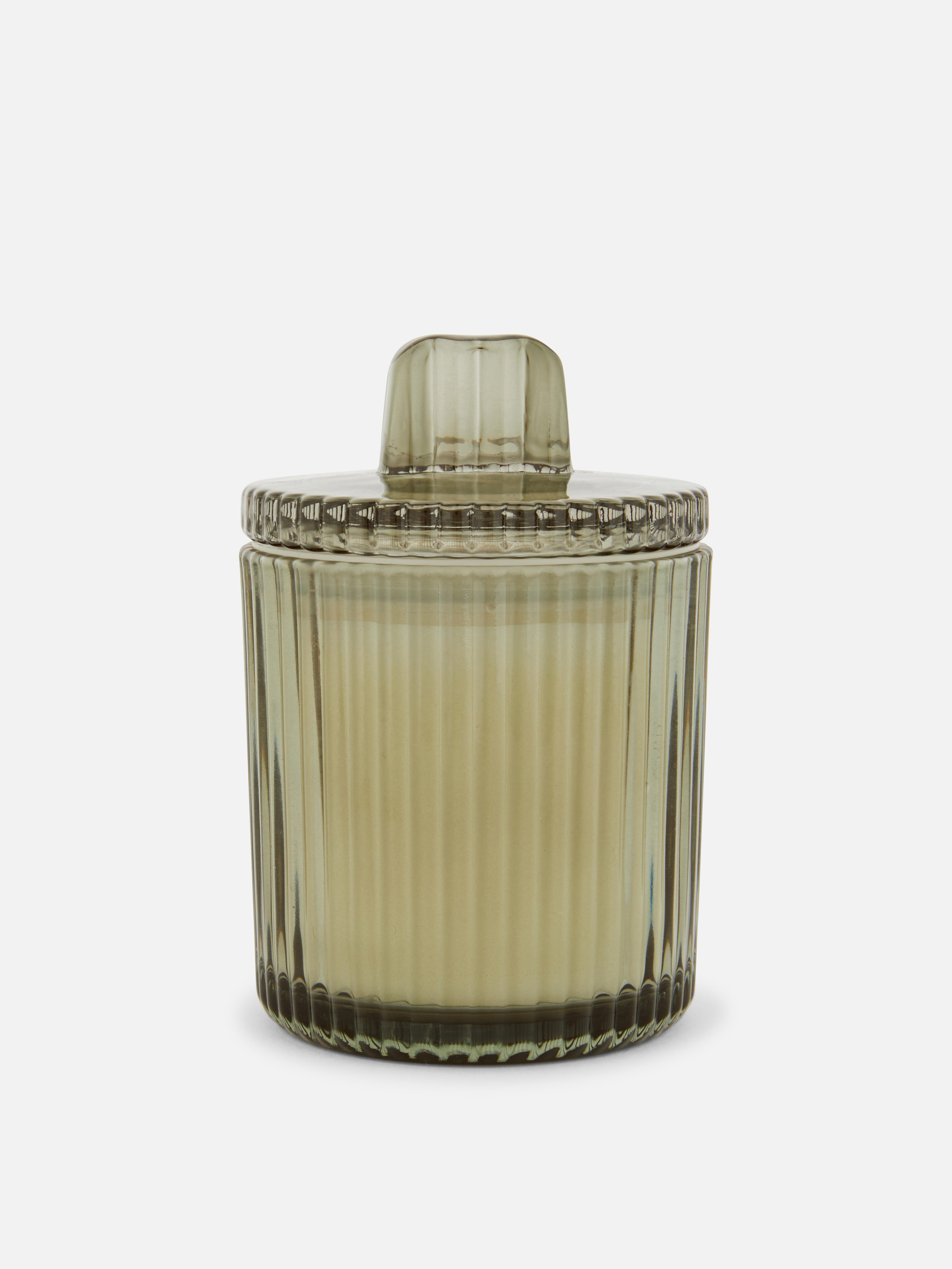 Vela perfumada em recipiente de vidro canelado